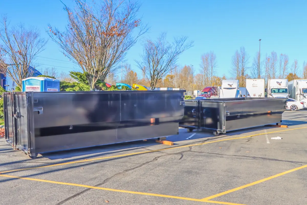 Professional dumpster rental service with roll-off container on residential driveway in Lathrop